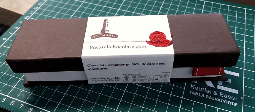 An early Bucareli box: dark board sleeve, printed belly band and a red wax seal, photographed on a cutting mat.